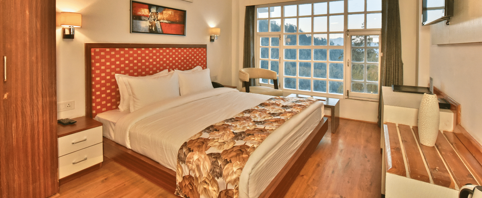 Bedroom with a wooden wardrobe next to it at DLS Hillcrest Resort, Shimla.